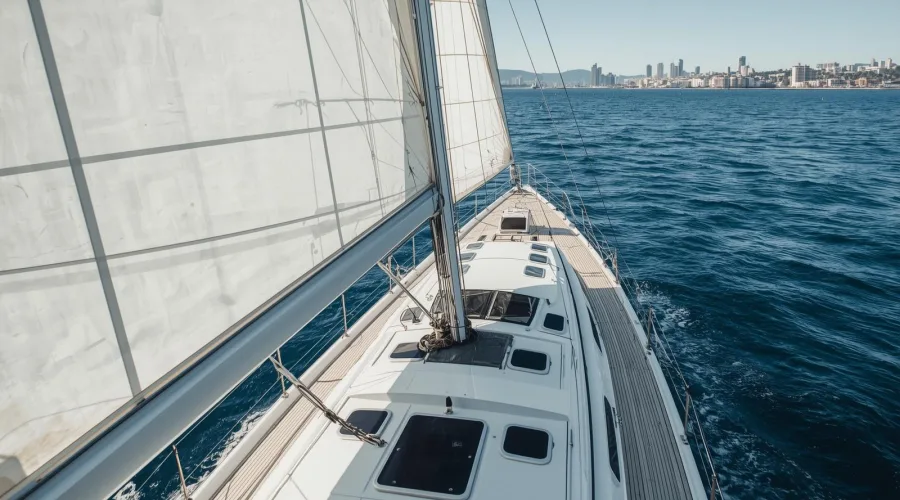 Vue depuis le pont d’un voilier naviguant face au skyline de Barcelone dans un cadre d’entreprise exclusif