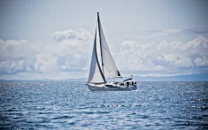 Charter sailing boat cruising with a small group off the Mediterranean Sea on a clear day
